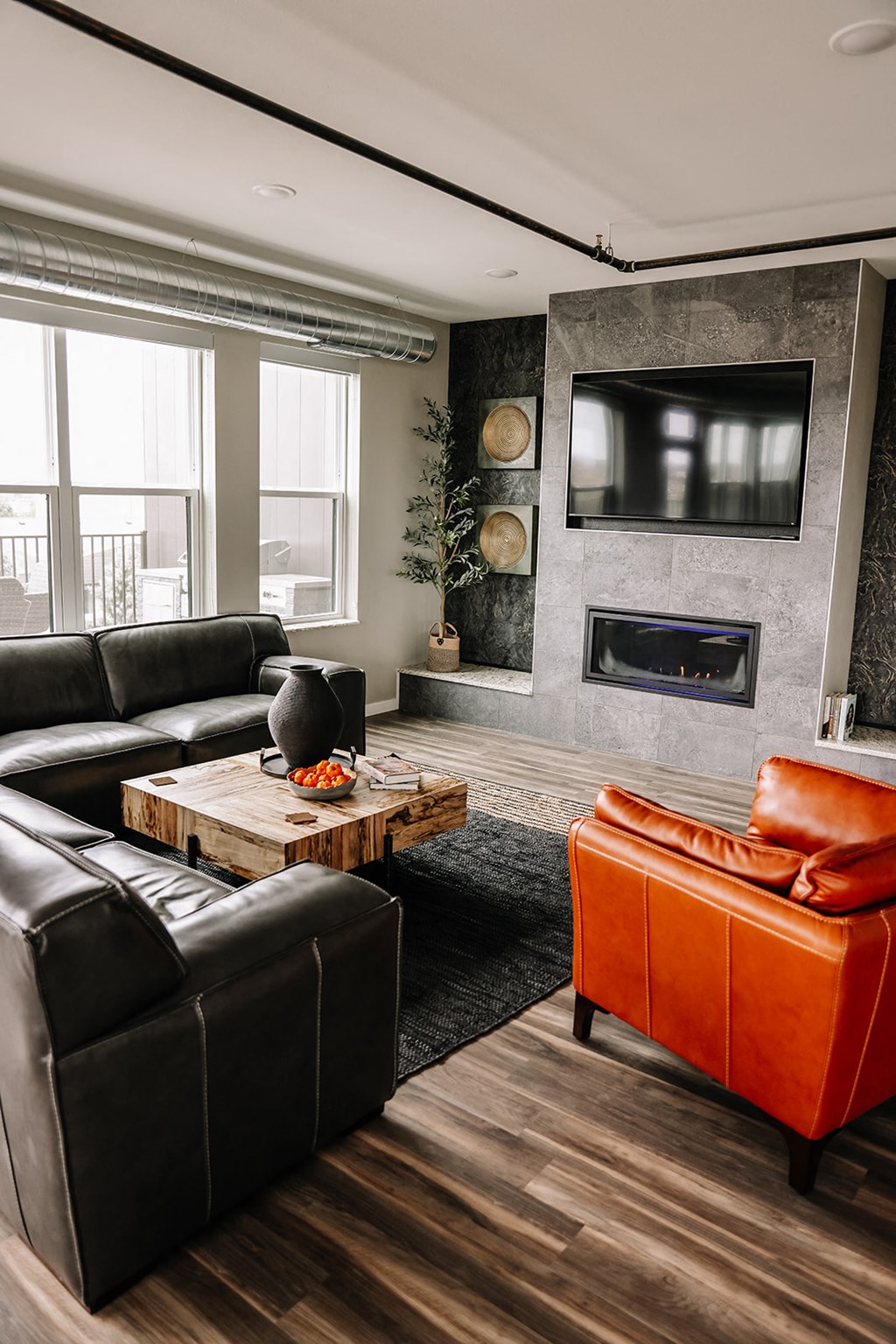 a living room with leather furniture and a fireplace