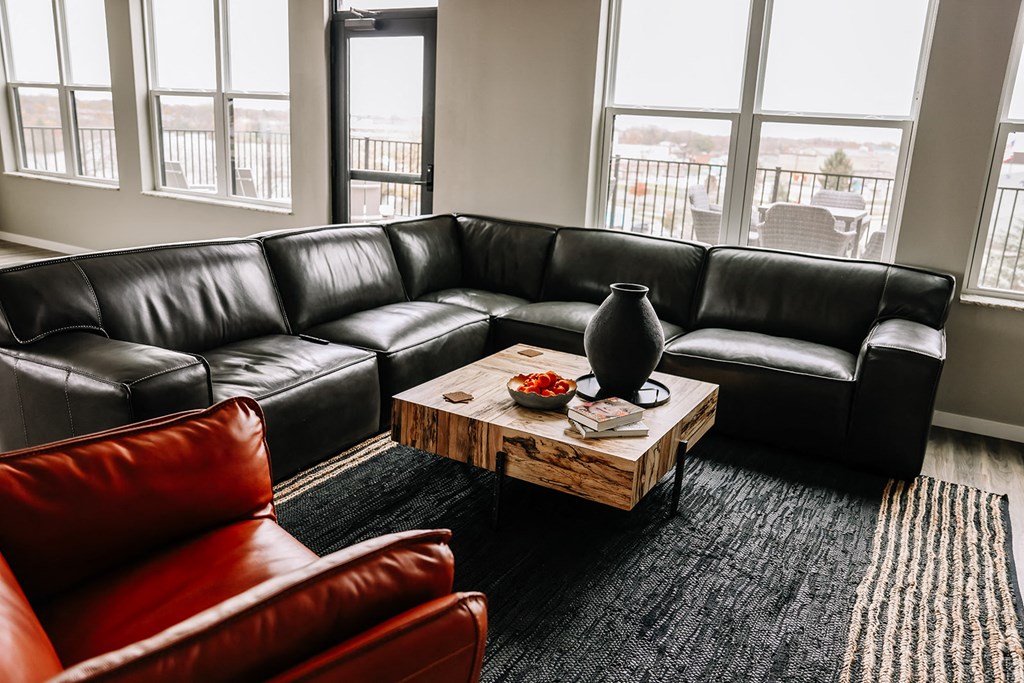 a living room with leather couches and a coffee table