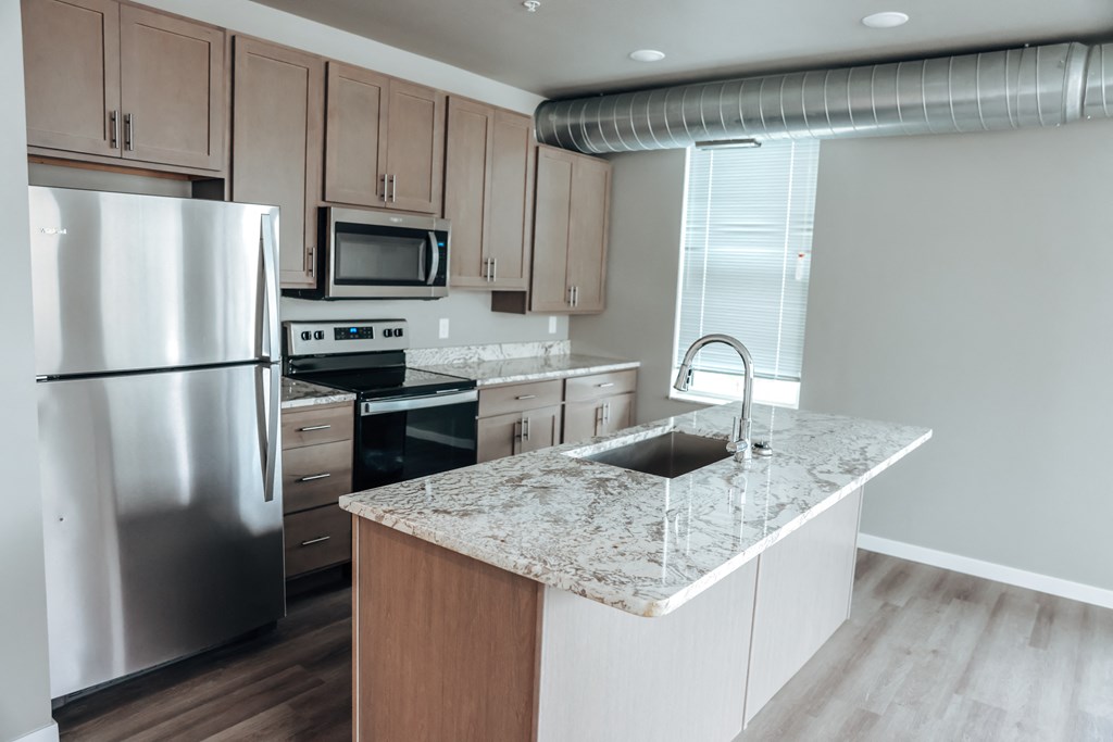 a kitchen with granite counter tops and stainless steel appliances