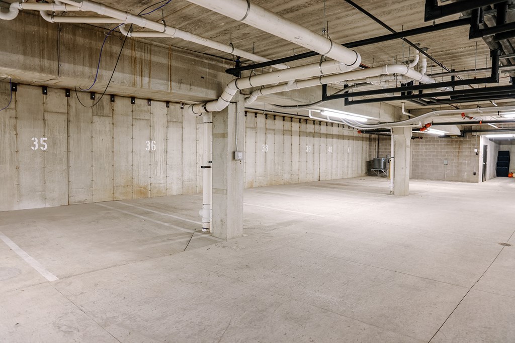 the inside of a building with white walls and exposed pipes