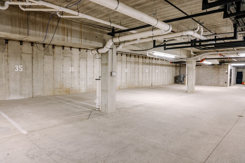 the inside of a building with white walls and exposed pipes