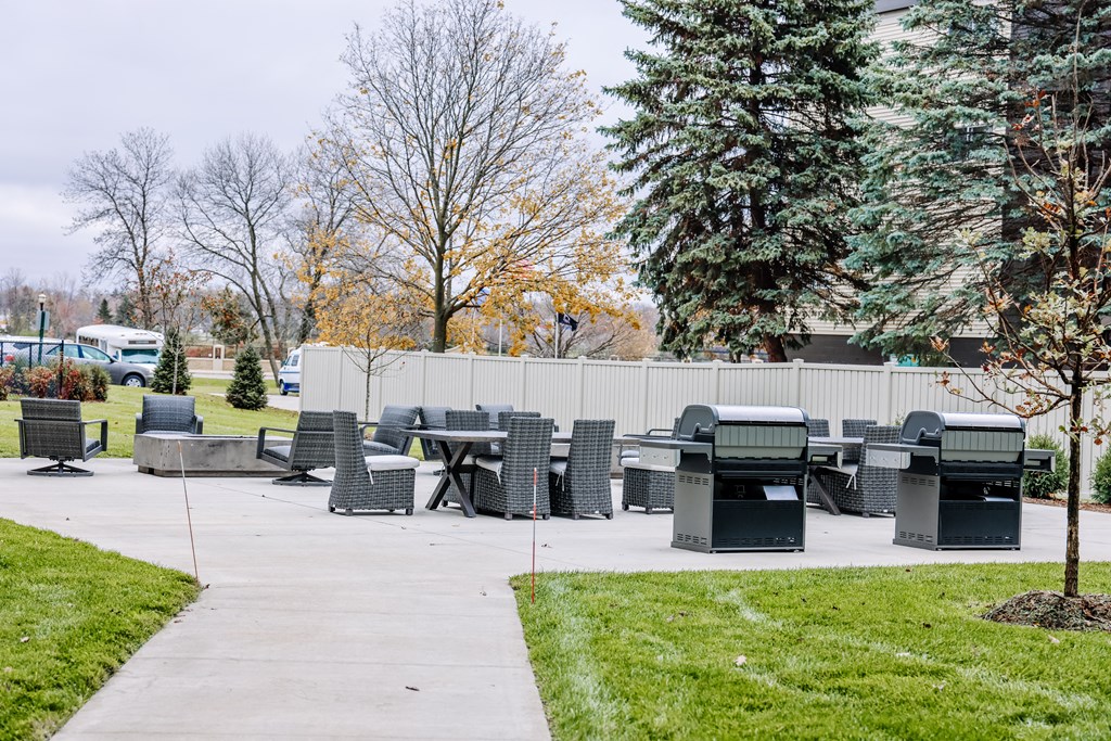 a patio with tables and chairs in a park