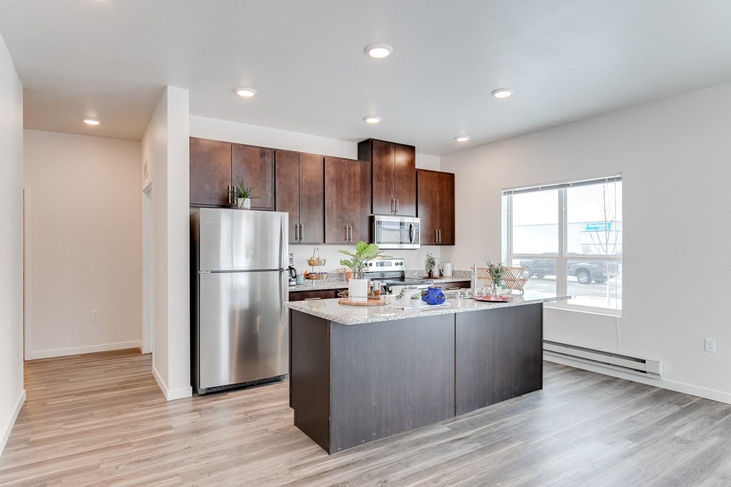 an open kitchen with stainless steel appliances and a large window