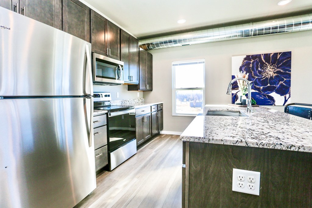 a kitchen with stainless steel appliances and granite counter tops