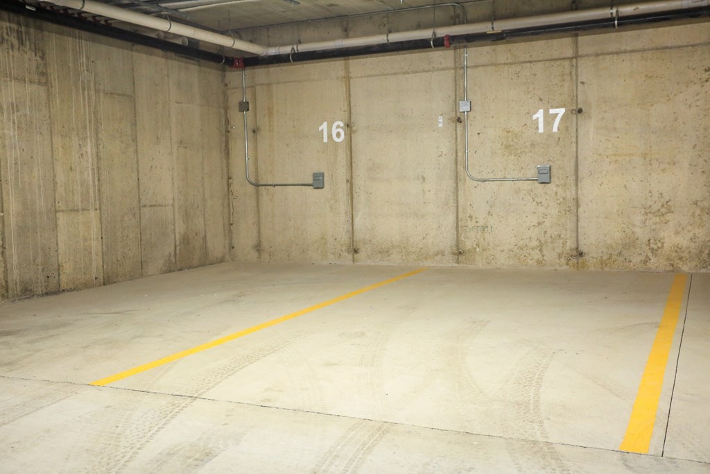 a parking garage with two doors and a yellow line on the floor
