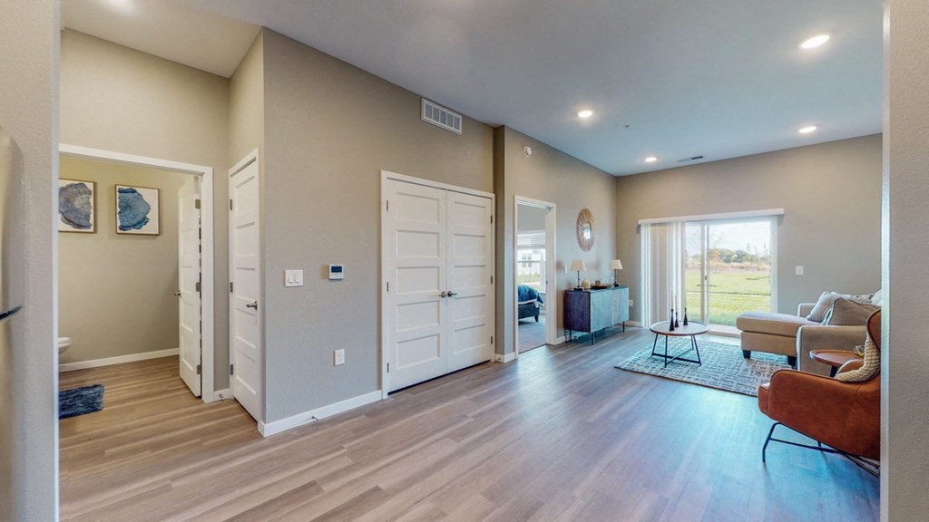 a living room with two doors and a couch and a table