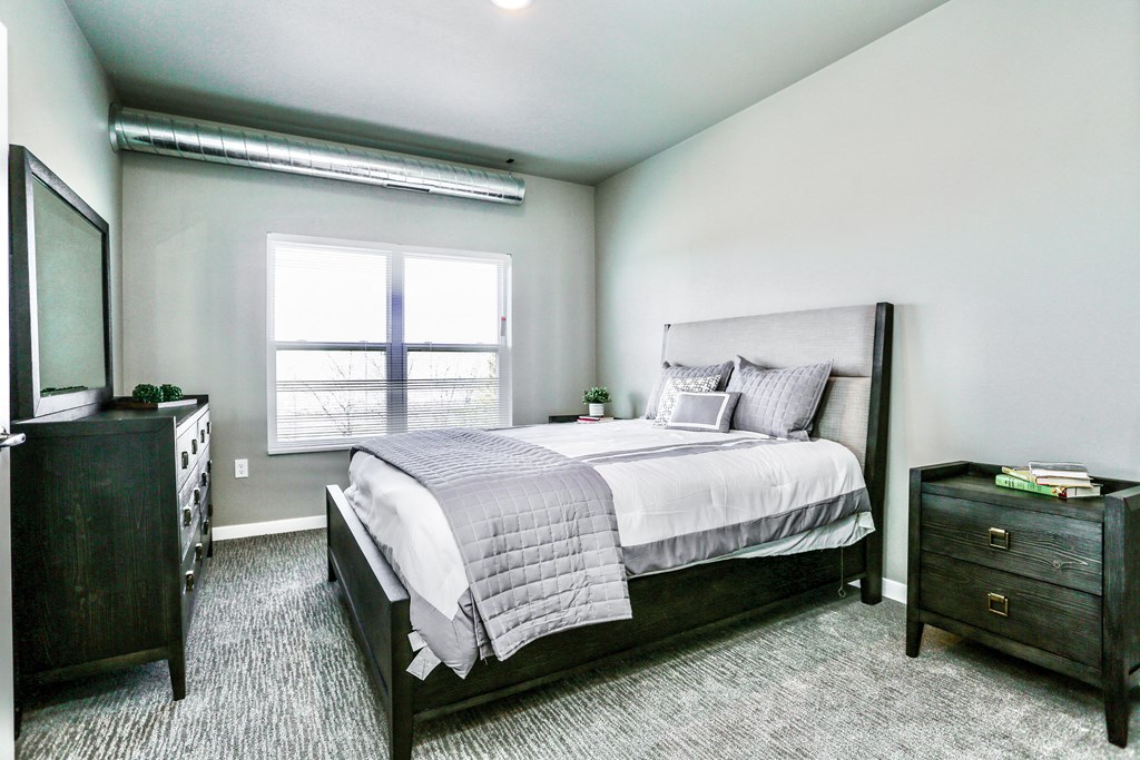 a bedroom with a bed and a window