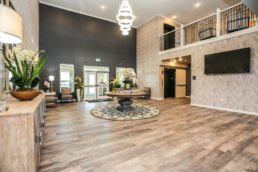 a lobby with a tv and a table