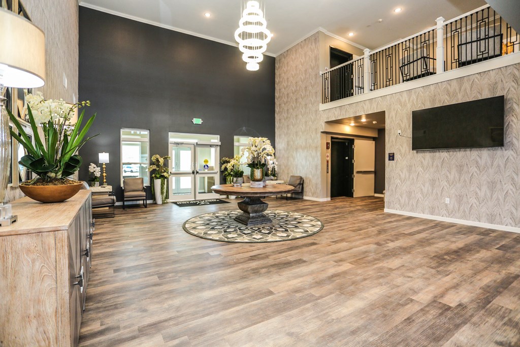 a large lobby with a tv and a table