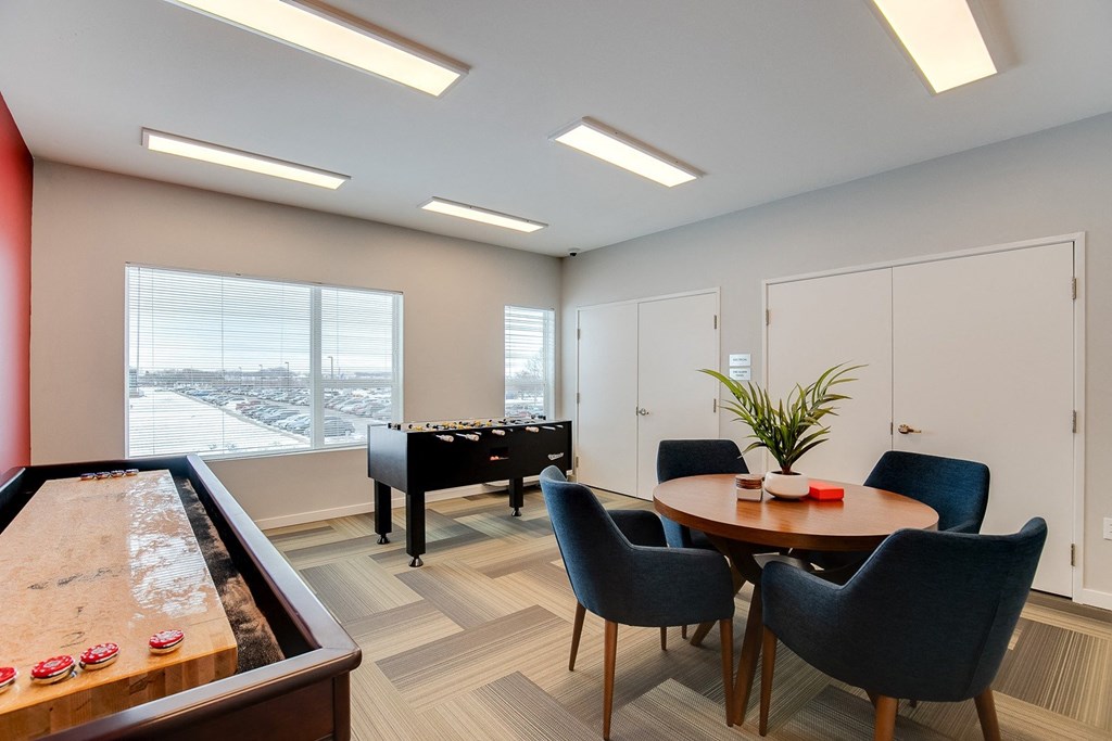 a living room with a piano and a table with chairs