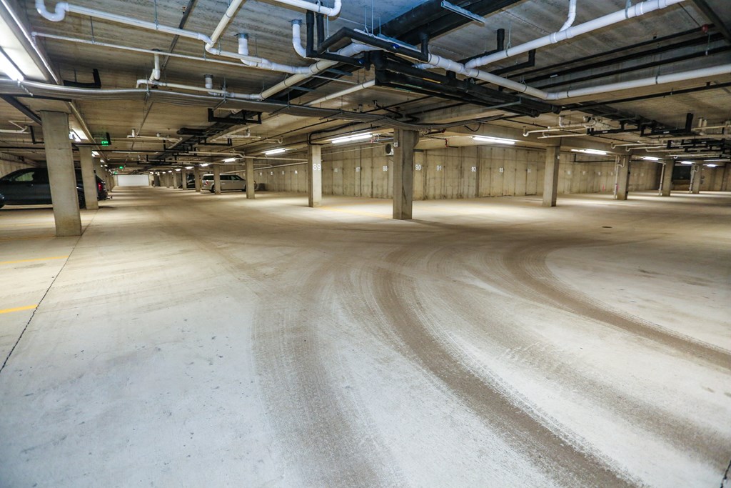 the floor of a parking garage is covered in dirt