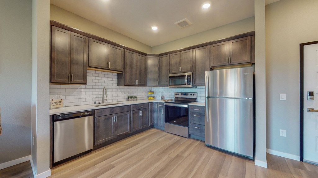 a kitchen with stainless steel appliances and wooden cabinets