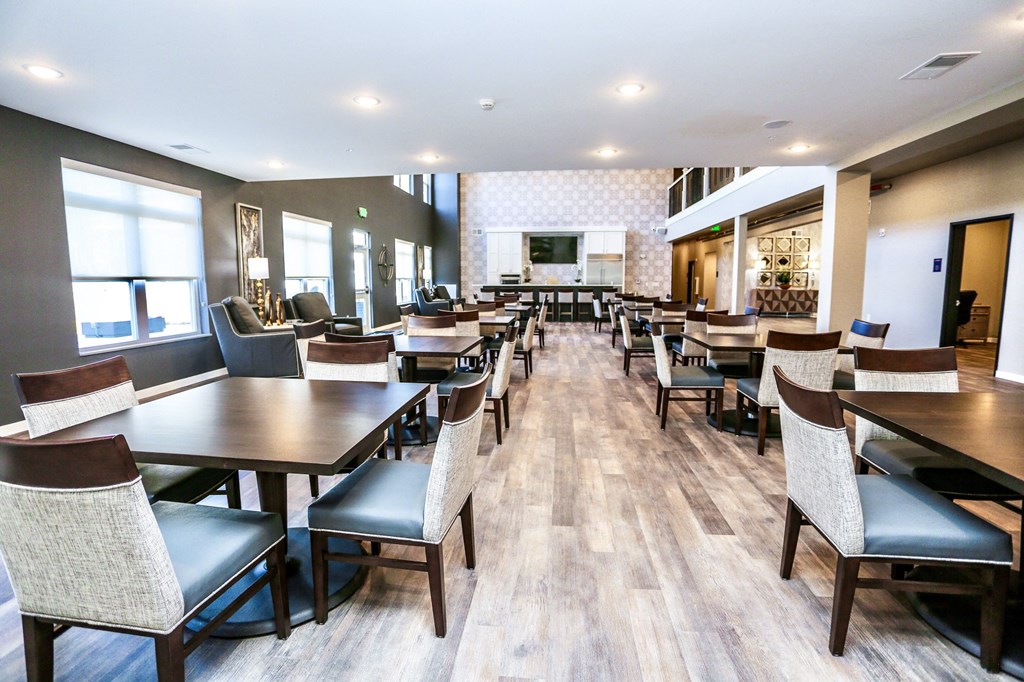 a large dining room with tables and chairs and a bar