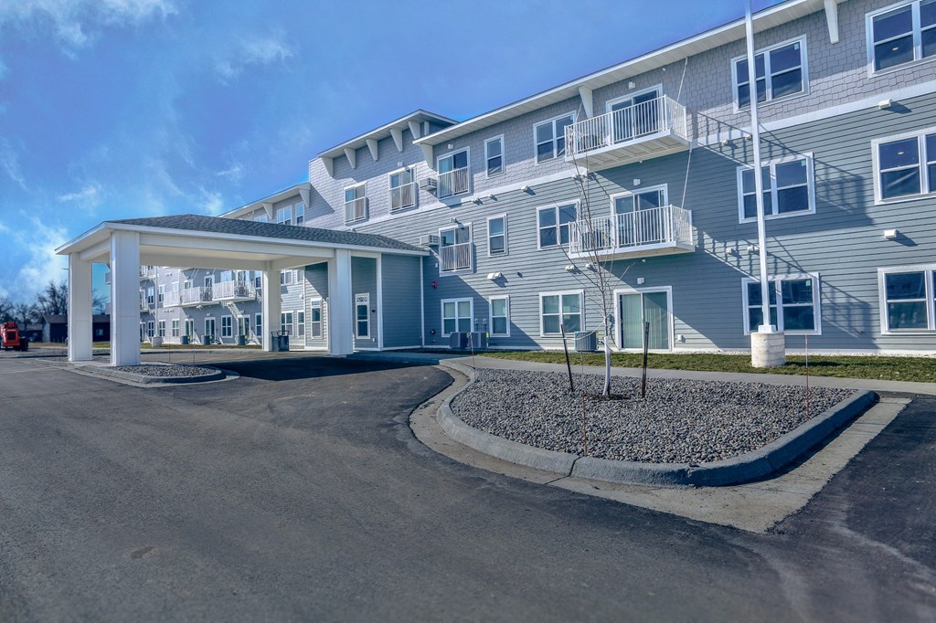 a building with a porch and a street in front of it
