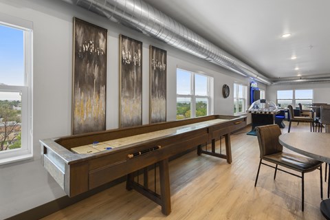 A room with a pool table and a chair.