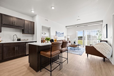 A modern kitchen with dark brown cabinets and a white countertop.