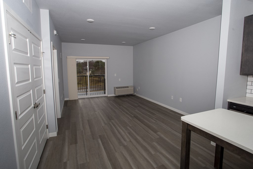 a kitchen and living room in a new home with wood flooring