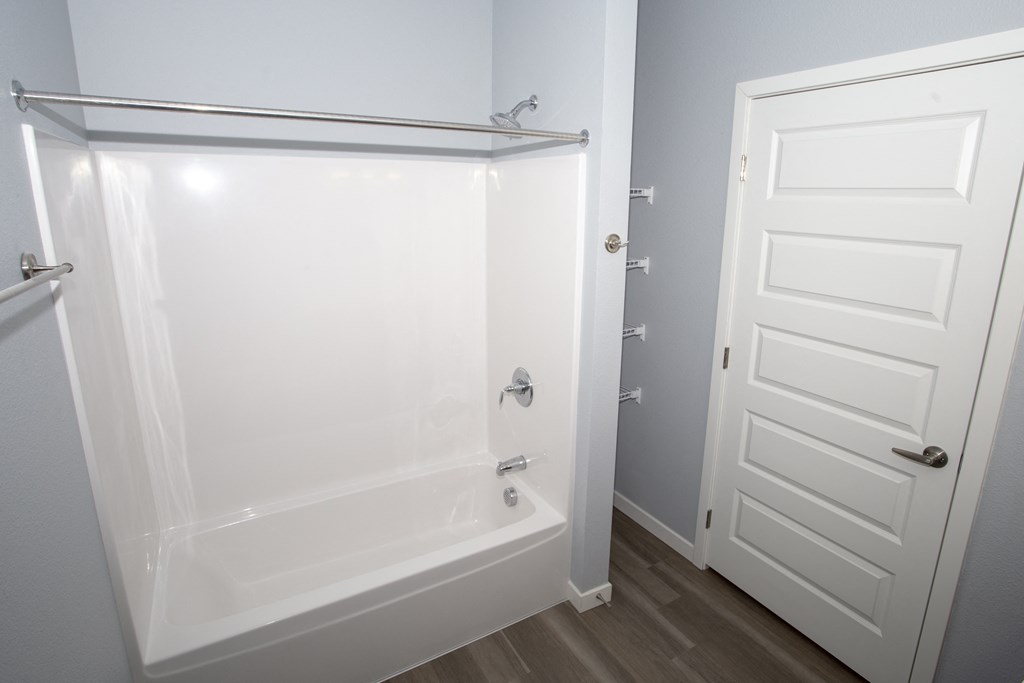 a small bathroom with a shower and a door