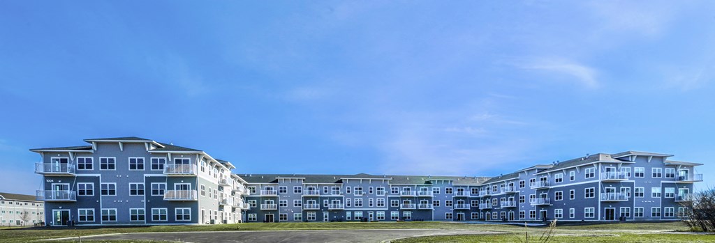 a row of new apartment buildings on a sunny day