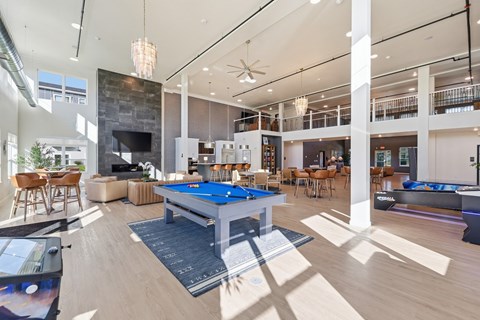 A large room with a pool table and a fireplace.