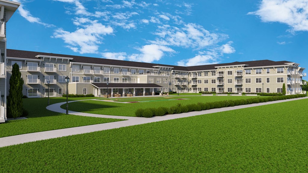 A large building with a green lawn in front.