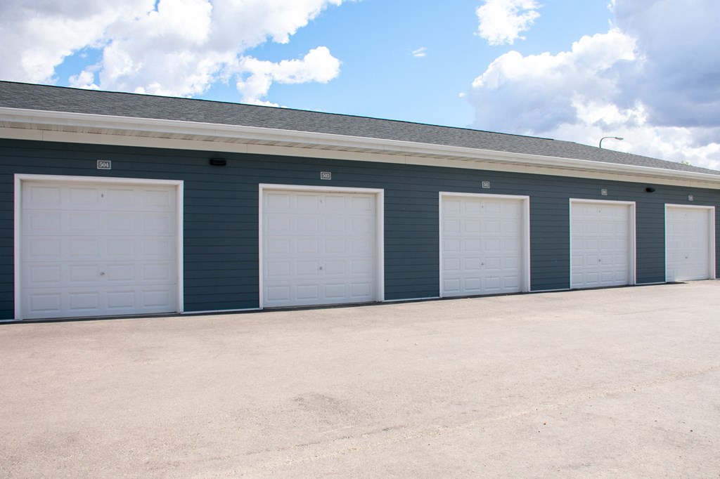 the inside of a blue building with white garage doors