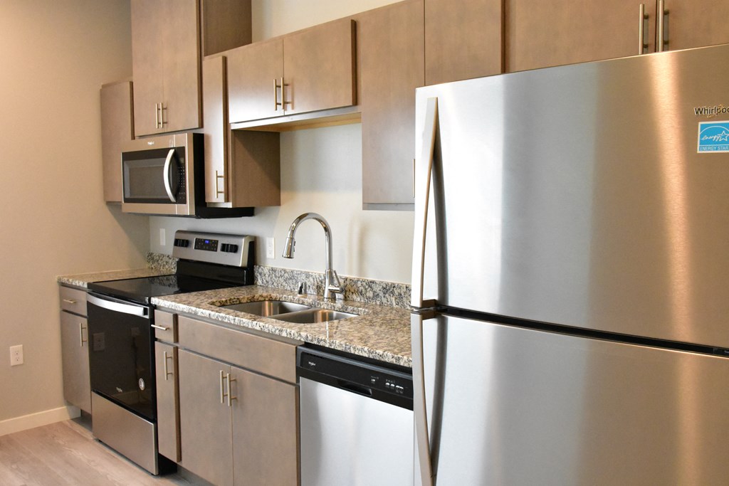 a kitchen with stainless steel appliances and granite counter tops