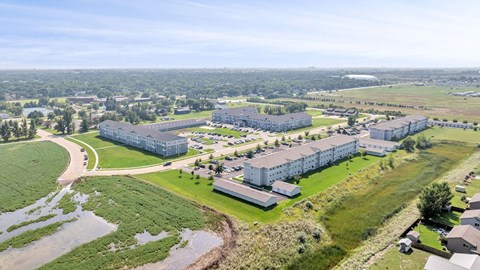A large building complex surrounded by a green field.