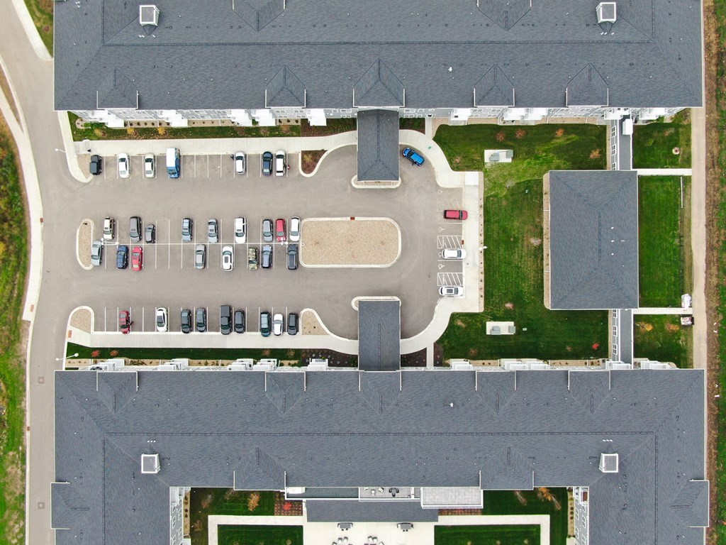 an aerial view of a parking lot with cars parked