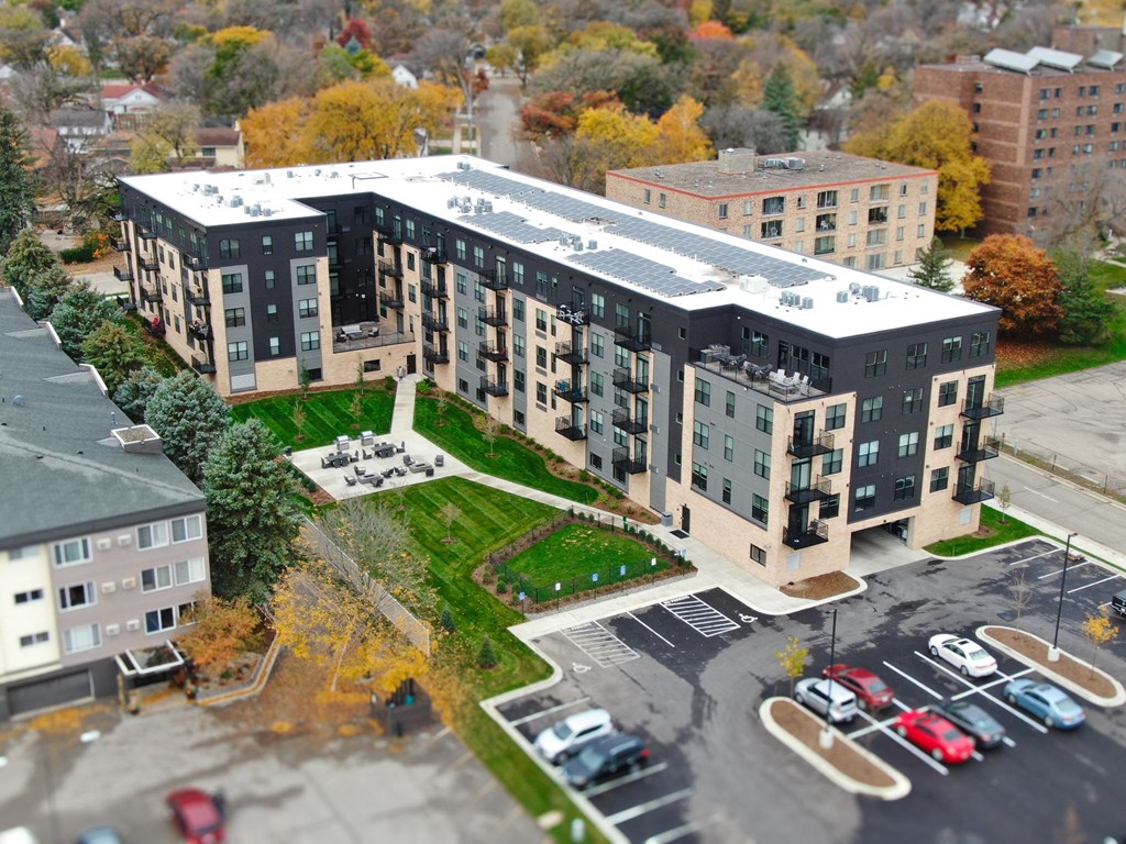 an aerial view of an apartment building with a rooftop garden