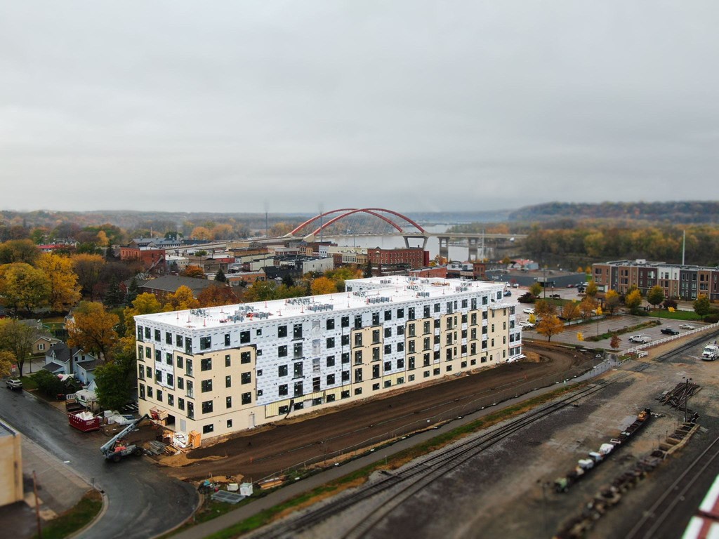 an aerial view of a building in a city with a rainbow bridge