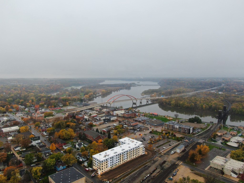 an aerial view of a city with a river and a bridge