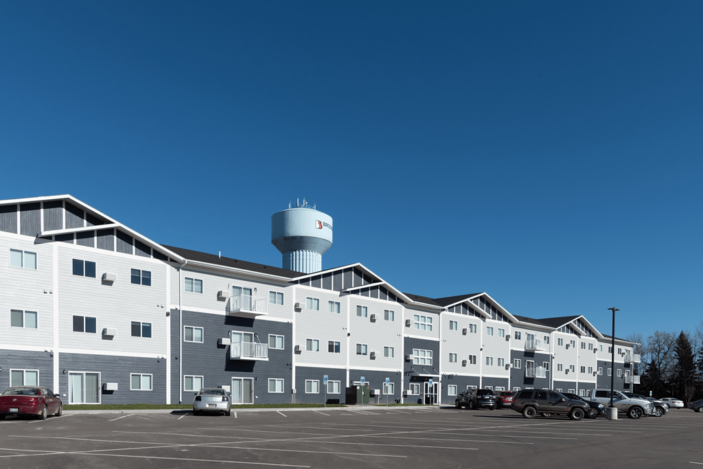 an apartment building with a water tower in the background