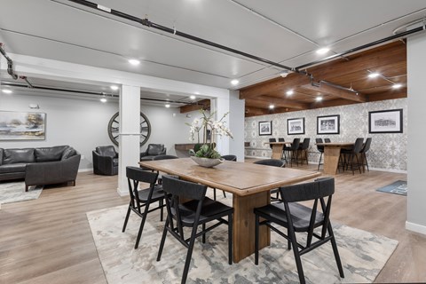 A dining room with a wooden table and chairs.