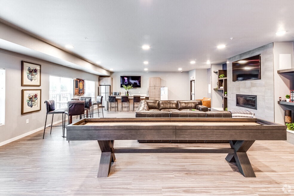 a living room with a pool table in the middle of it