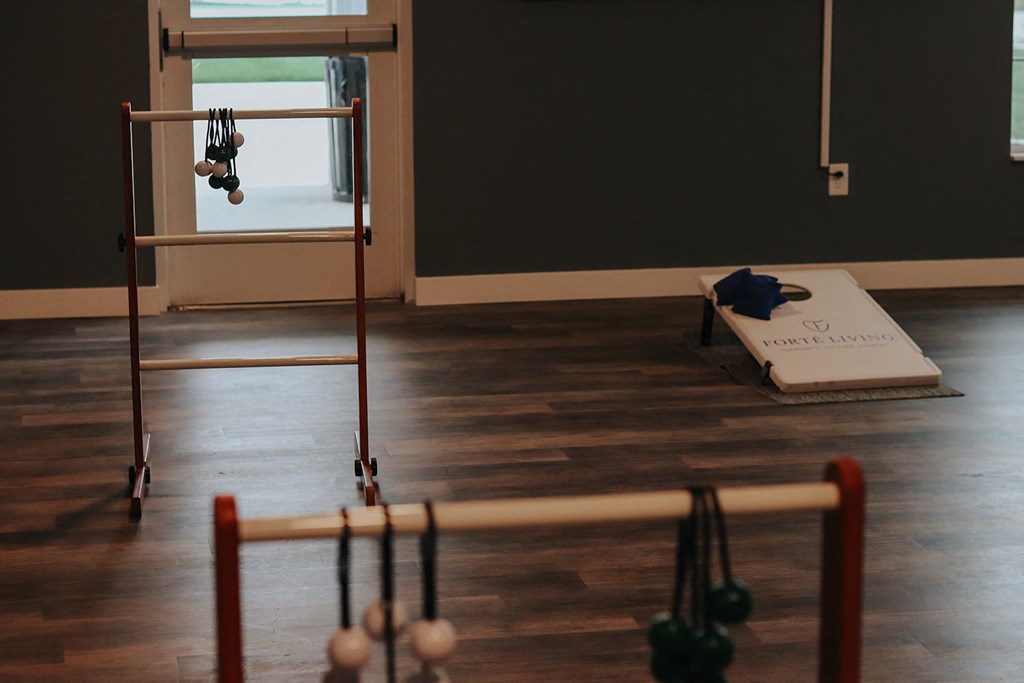 a room with a yoga studio and weights on the floor