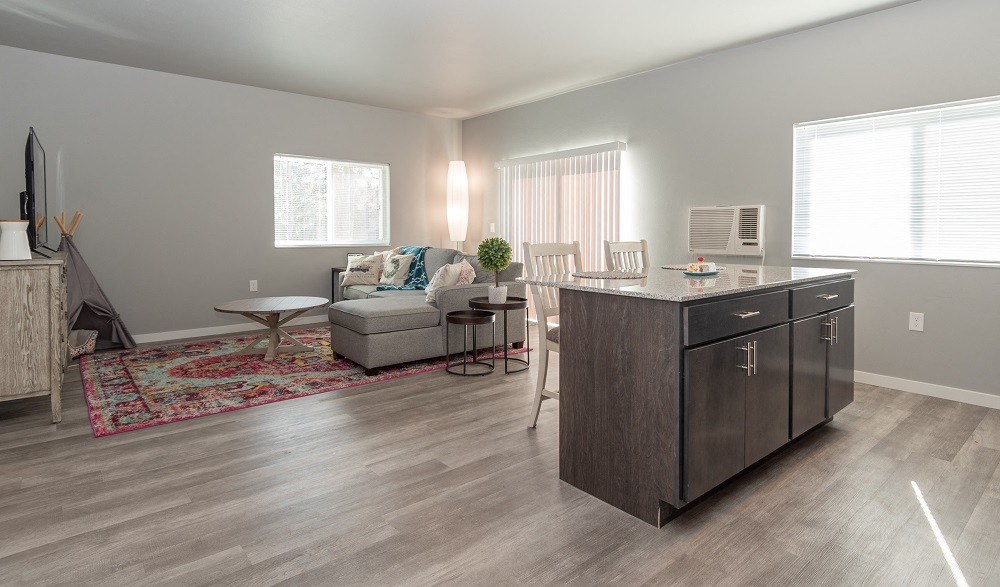 an open living room and kitchen with a couch and a table