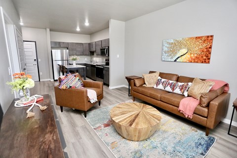 A living room with a brown couch and a wooden coffee table.