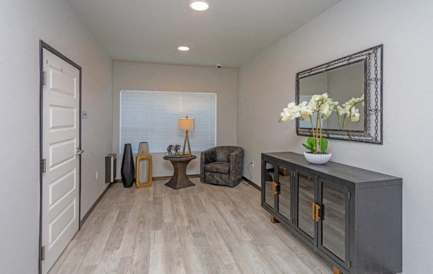 a living room with a dresser and a mirror