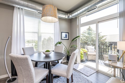A dining room with a round table and chairs.