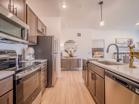 A modern kitchen with wooden cabinets and stainless steel appliances.