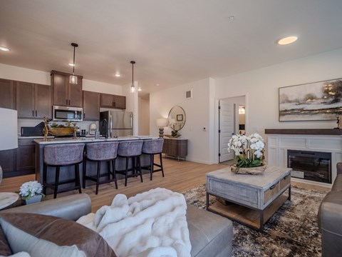 A modern living room with a fireplace and a dining area.