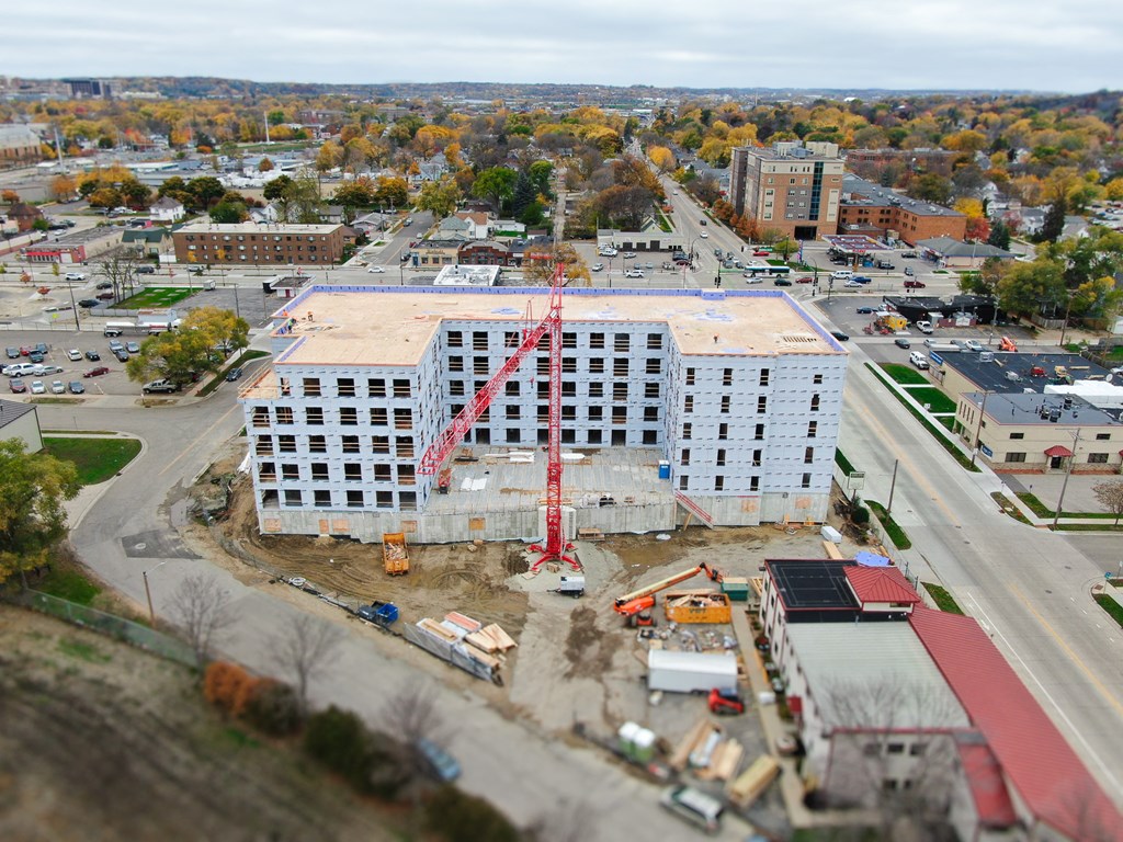 an aerial view of a building under construction with a crane