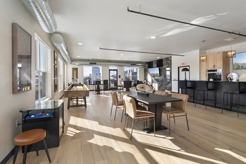 A modern kitchen with a dining table and chairs.