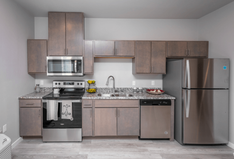 a kitchen with stainless steel appliances and wooden cabinets
