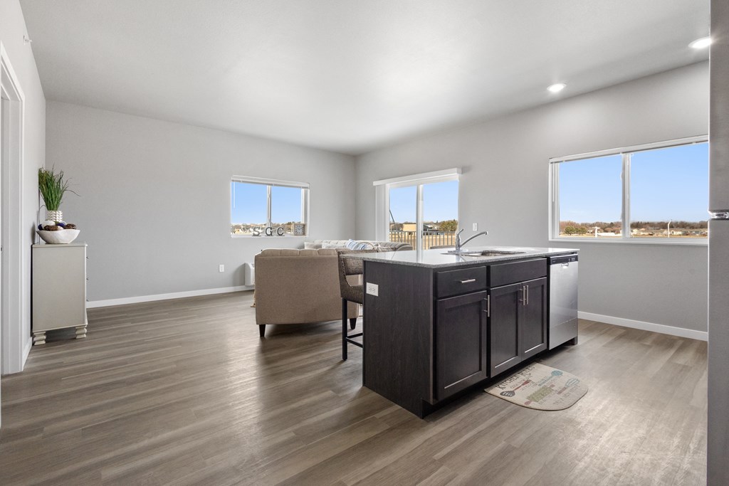 a living room with a kitchen and a dining room