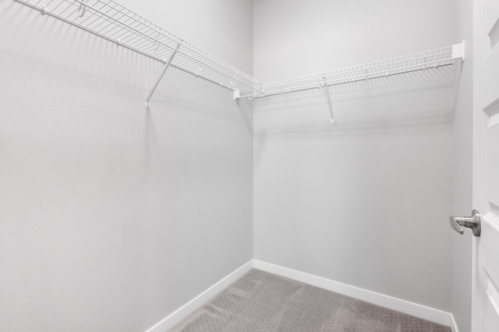 an empty room with white walls and a white closet