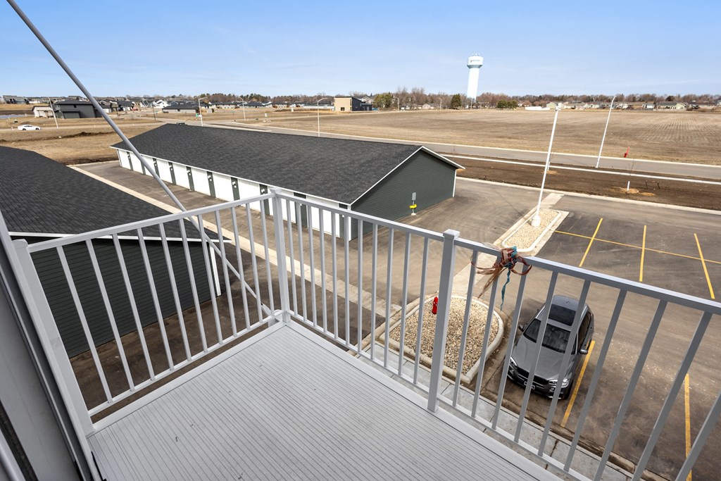 a rooftop view of a building with a truck parked in a parking lot