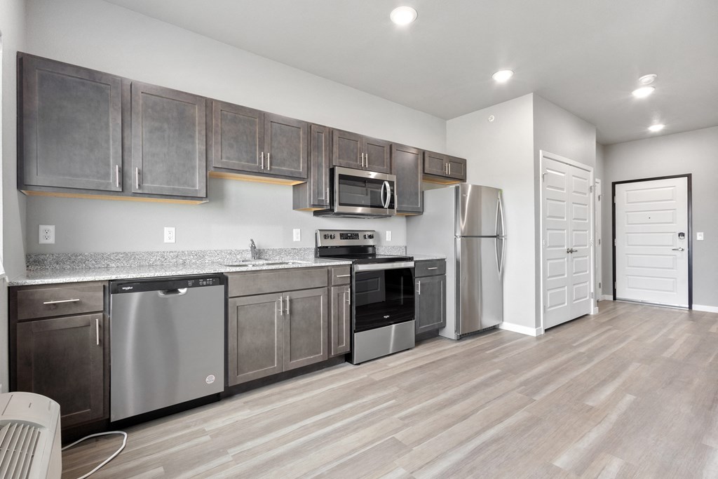 a kitchen with stainless steel appliances and wooden cabinets