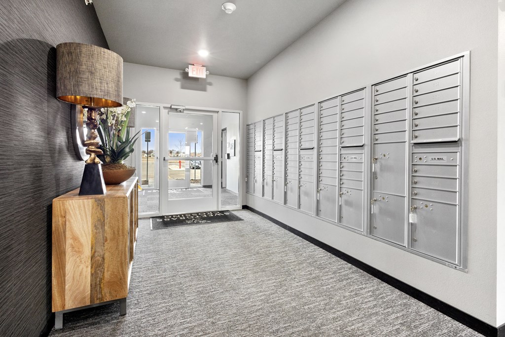 a long hallway with a row of lockers and a lamp